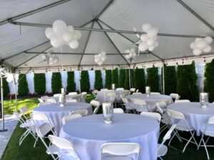 outdoor event with white balloon decor in tent