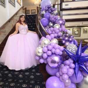 purple balloons on stairs for quinceanera