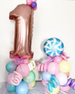 pastel candy themed balloons for 1st birthday