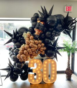 black and gold 30th birthday balloon arch