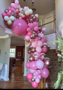 large pink balloon garland on stairwell