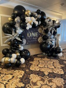 large black and gold balloon column