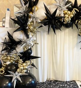 gold and black balloon arch