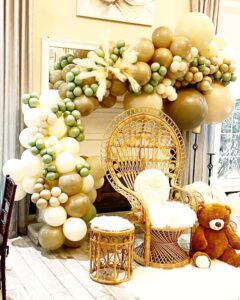 brown, white, and green baby shower balloon arch